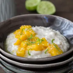Cremiger Milchreis mit süßen Mangostücken und Kokosraspeln, eine köstliche Variante von Mango Sticky Rice.